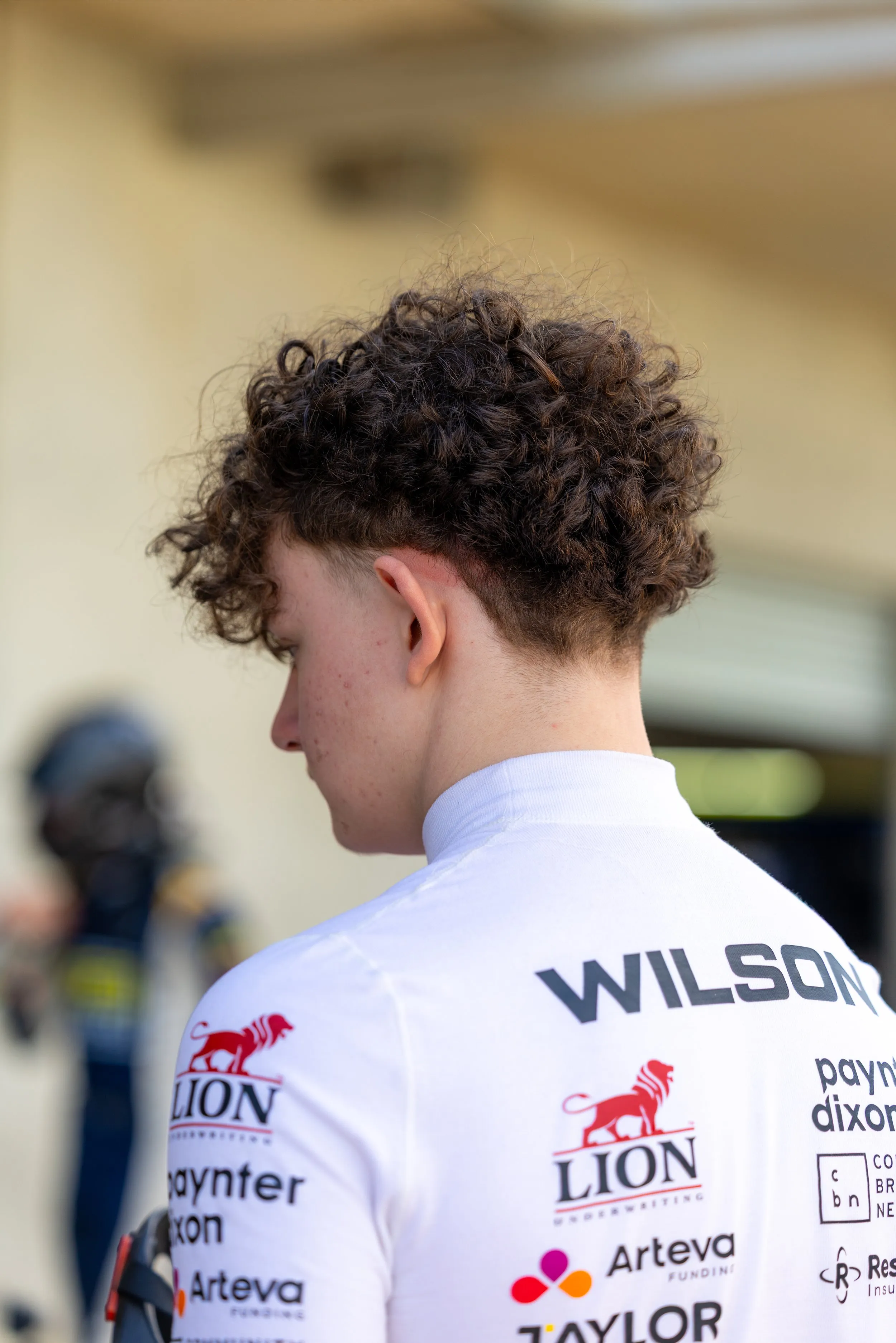 Koby seen from behind, WILSON across his shoulders above the Lion, Paynter Dixon, Arteva and Taylor logos